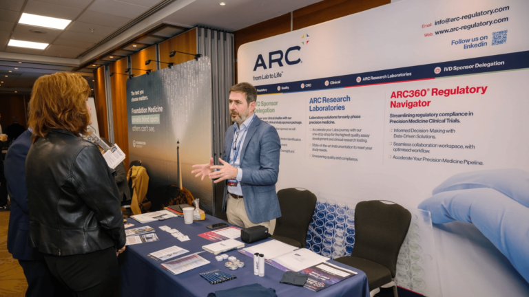 Business professionals discussing partnership opportunities at a life sciences conference exhibition.