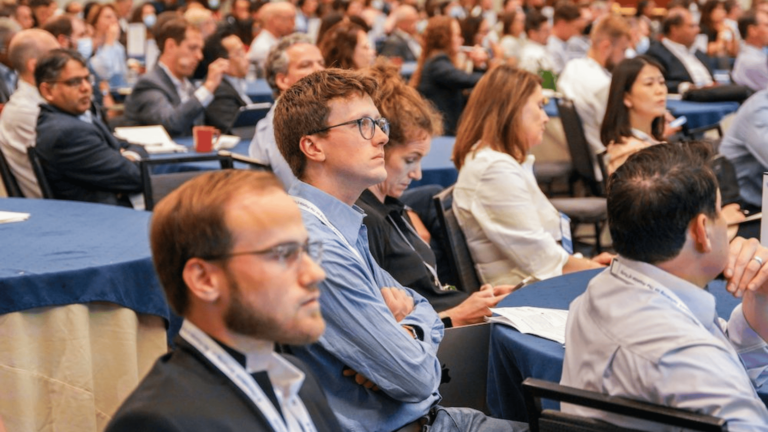 Conference attendees engaging in discussions and networking during a drug discovery industry event.