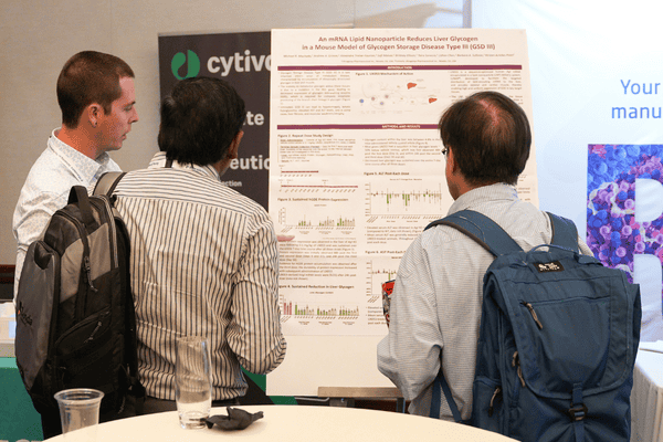 Scientist presenting research findings through a scientific poster at a drug discovery conference.