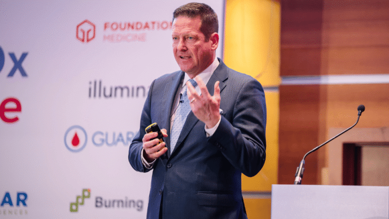 Industry expert delivering a presentation to an audience of pharmaceutical and biotechnology professionals.