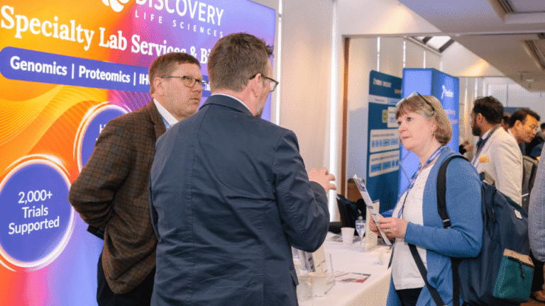 Exhibition stand engaging conference attendees at a life sciences industry event.