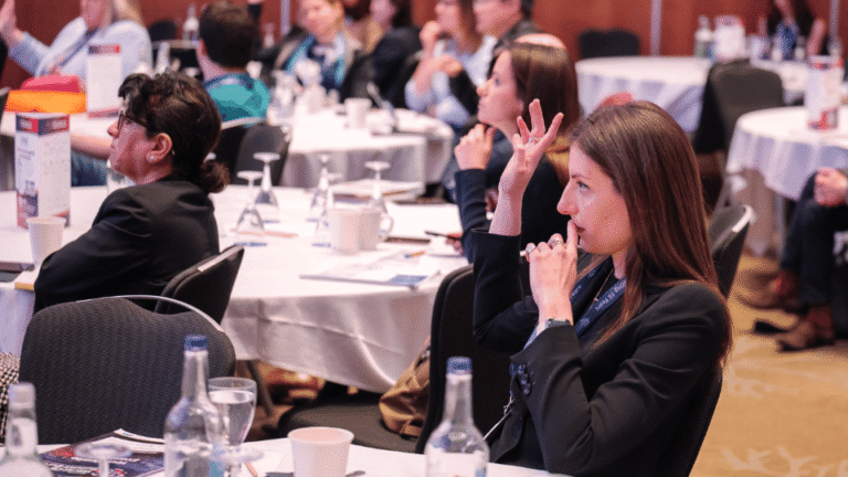 Conference attendees networking and exchanging contact information during a business event.