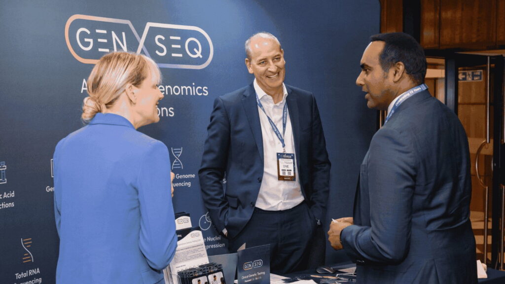 Business professionals discussing partnership opportunities during a life sciences industry event.